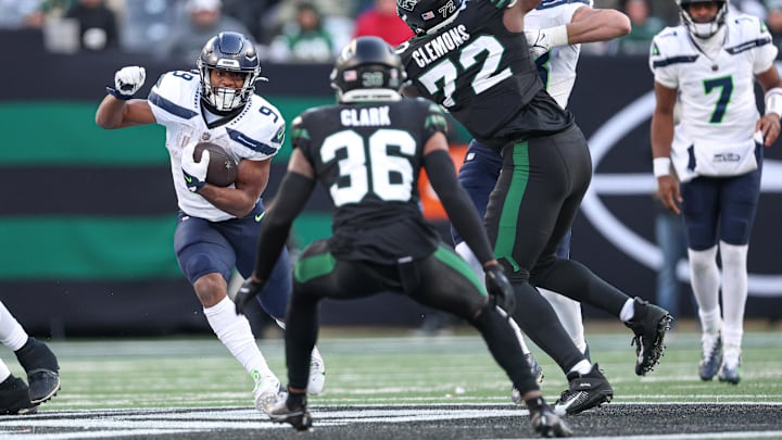 Dec 1, 2024; East Rutherford, New Jersey, USA; Seattle Seahawks running back Kenneth Walker III (9) carries the ball as New York Jets safety Chuck Clark (36) pursues during the first half at MetLife Stadium.