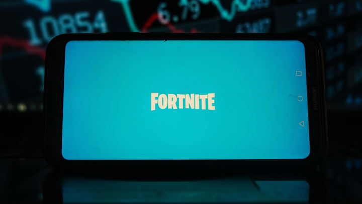In this photo illustration a Fortnite logo seen displayed on...