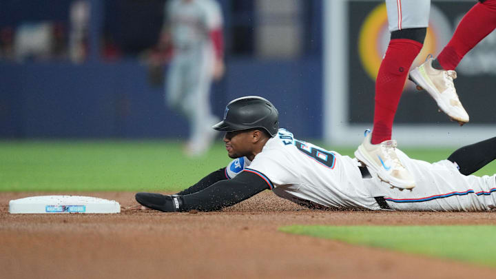 Aug 8, 2024; Miami, Florida, USA; Miami Marlins shortstop Xavier Edwards (63) steals second base against the Cincinnati Reds in the first inning at loanDepot Park.
