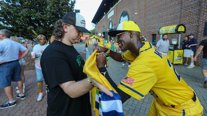 Reggie Horton signs an autograph for a fan on Saturday, September 28, 2024 during the Savannah Bananas' final home series of the season at Historic Grayson Stadium.
