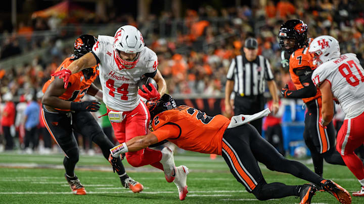 Sep 26, 2025; Corvallis, Oregon, USA; Houston Cougars running back Dean Connors (44) runs the ball and is tackled by Oregon State Beavers defensive back Jalil Tucker (2) during the second quarter at Reser Stadium. Mandatory Credit: Craig Strobeck-Imagn Images