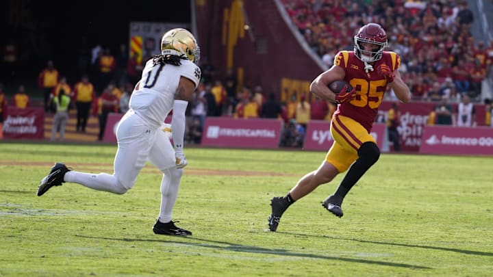 Nov 30, 2024; Los Angeles, California, USA; Southern California Trojans tight end Walker Lyons (85) carries the ball against Notre Dame Fighting Irish safety Xavier Watts (0) in the second half at United Airlines Field at Los Angeles Memorial Coliseum. Mandatory Credit: Kirby Lee-Imagn Images Nov 30, 2024; Los Angeles, California, USA; Southern California Trojans tight end Walker Lyons (85) carries the ball against Notre Dame Fighting Irish safety Xavier Watts (0) in the second half at United Airlines Field at Los Angeles Memorial Coliseum. Mandatory Credit: Kirby Lee-Imagn Images
