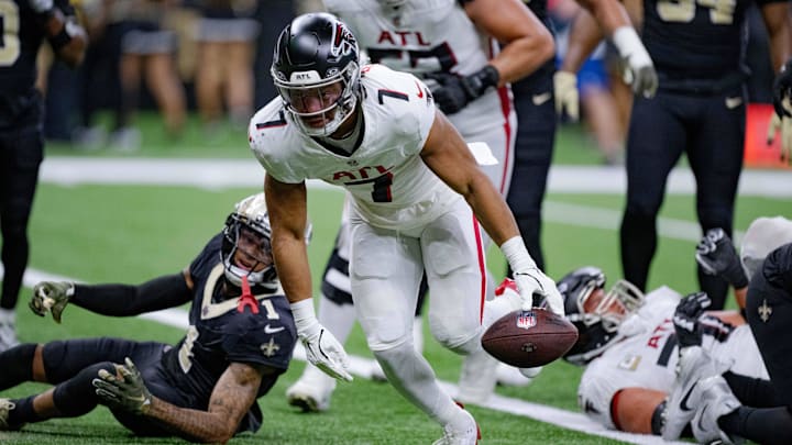 Nov 10, 2024; New Orleans, Louisiana, USA; Atlanta Falcons running back Bijan Robinson (7) breaks past New Orleans Saints cornerback Alontae Taylor (1) for touchdown during the first half at Caesars Superdome. Mandatory Credit: Matthew Hinton-Imagn Images