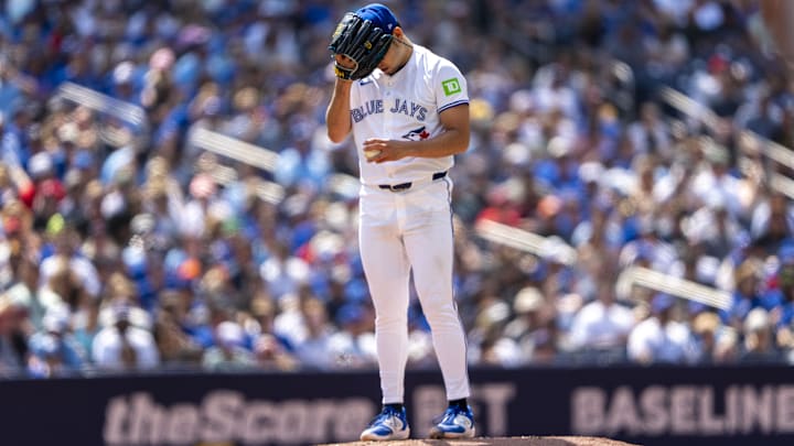 Jul 20, 2024; Toronto, Ontario, CAN; Toronto Blue Jays pitcher Yusei Kikuchi (16) covers his head with his glove during the first inning against the Detroit Tigers at Rogers Centre. Mandatory Credit: Kevin Sousa-USA TODAY Sports