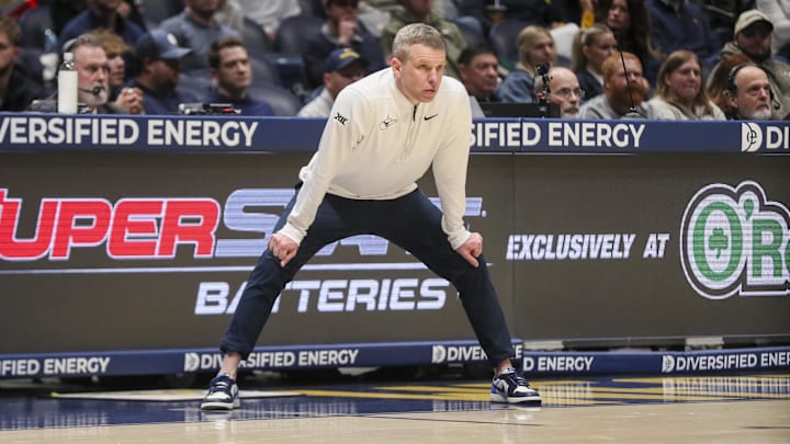 Jan 27, 2026; Morgantown, West Virginia, USA; West Virginia Mountaineers head coach Ross Hodge watches a play during the first half against the Kansas State Wildcats at Hope Coliseum. Mandatory Credit: Ben Queen-Imagn Images