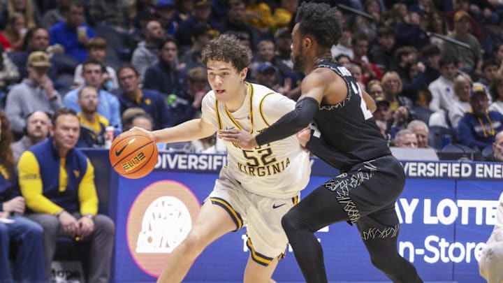Jan 17, 2026; Morgantown, West Virginia, USA; West Virginia Mountaineers guard Treysen Eaglestaff (52) dribbles aggaainst Colorado Buffaloes guard Barrington Hargress (24) during the second half at Hope Coliseum. Mandatory Credit: Ben Queen-Imagn Images