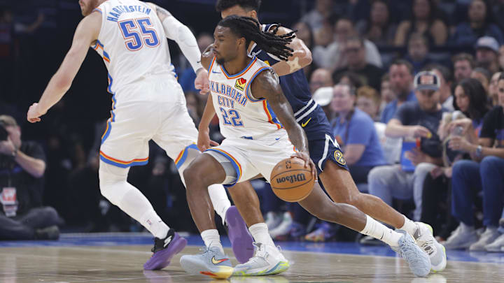 Oct 17, 2025; Oklahoma City, Oklahoma, USA; Oklahoma City Thunder guard Cason Wallace (22) moves past Denver Nuggets forward Cameron Johnson (23) during the first half at Paycom Center.