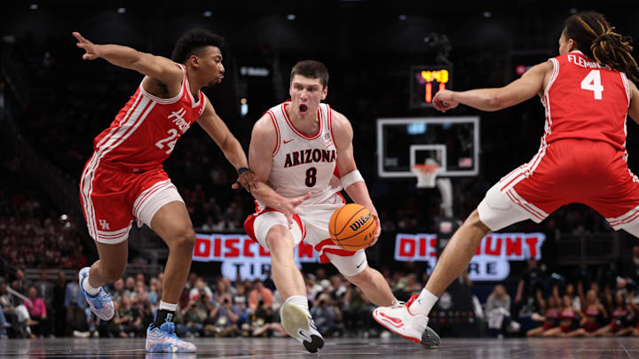Mar 14, 2026; Kansas City, MO, USA; Arizona Wildcats forward Ivan Kharchenkov (8) drives to the hoop past Houston Cougars forward Chase McCarty (24) and guard Kingston Flemings (4) during the first half during the men's Big 12 Conference Tournament Championship at T-Mobile Center. Mar 14, 2026; Kansas City, MO, USA; Arizona Wildcats forward Ivan Kharchenkov (8) drives to the hoop past Houston Cougars forward Chase McCarty (24) and guard Kingston Flemings (4) during the first half during the men's Big 12 Conference Tournament Championship at T-Mobile Center.