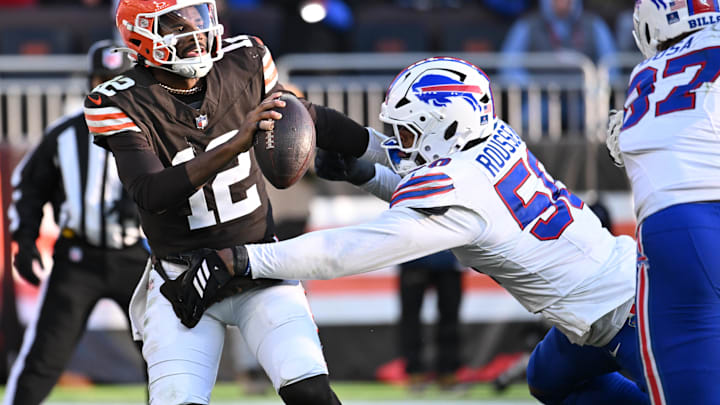 Dec 21, 2025; Cleveland, Ohio, USA;  Cleveland Browns quarterback Shedeur Sanders (12) is pressures by. Buffalo Bills defensive end Greg Rousseau (50) during the second half at Huntington Bank Field. 