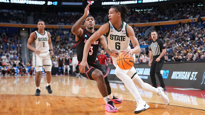 Mar 21, 2026; Buffalo, NY, USA; Michigan State Spartans forward Jordan Scott (6) drives the ball while defended by Louisville Cardinals guard Ryan Conwell (3) in the second half during a second round game of the men's 2026 NCAA Tournament at Keybank Center. Mandatory Credit: Gregory Fisher-Imagn Images