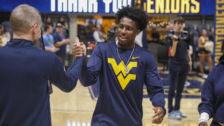 Mar 6, 2026; Morgantown, West Virginia, USA; West Virginia Mountaineers guard Honor Huff (3) hugs West Virginia Mountaineers head coach Ross Hodge during Senior Night activities before the game against the UCF Knights at Hope Coliseum. Mandatory Credit: Ben Queen-Imagn Images Mar 6, 2026; Morgantown, West Virginia, USA; West Virginia Mountaineers guard Honor Huff (3) hugs West Virginia Mountaineers head coach Ross Hodge during Senior Night activities before the game against the UCF Knights at Hope Coliseum. Mandatory Credit: Ben Queen-Imagn Images