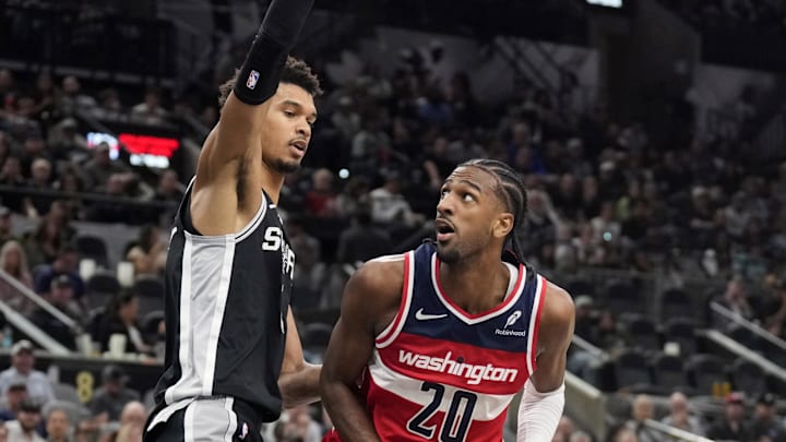 Nov 13, 2024; San Antonio, Texas, USA; Washington Wizards forward Alex Sarr (20) drives to the basket while defended by San Antonio Spurs center Victor Wembanyama (1) during the second half at Frost Bank Center. Mandatory Credit: Scott Wachter-Imagn Images