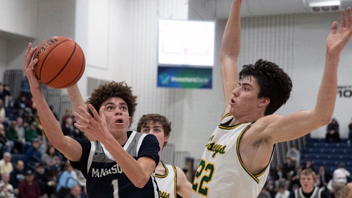 Manasquan Darius Adams puts in a shot as he is guarded by RBC Gioacchino Panzini in first half action. Manasquan vs Red Bank Catholic Boys Basketball in Shore Conference Tournament Semifinals in Toms River NJ on February 24, 2022.

Bbsqrc220224a
