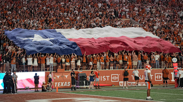 Sep 20, 2025; Austin, Texas, USA; Texas Longhorns fans hold the Texas state flag during a timeout in the first half against the Sam Houston Bearkats at Darrell K Royal-Texas Memorial Stadium. Mandatory Credit: Scott Wachter-Imagn Images