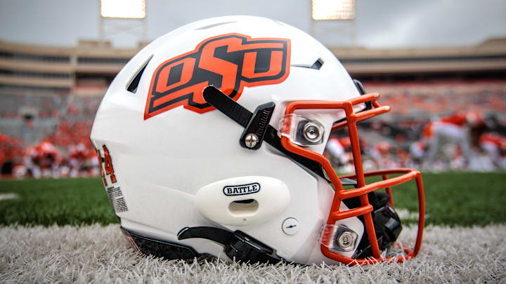 Aug 31, 2024; Stillwater, Oklahoma, USA; Oklahoma State Cowboys helmet sits on the field prior to the game against the South Dakota State Jackrabbits at Boone Pickens Stadium. Mandatory Credit: William Purnell-Imagn Images