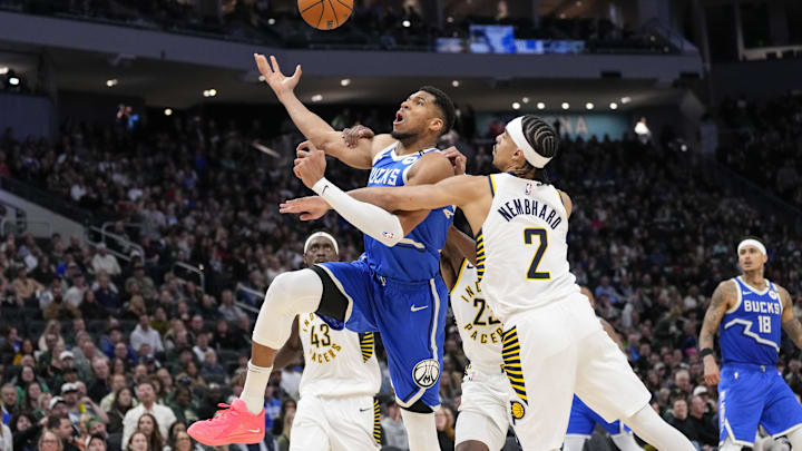Mar 15, 2025; Milwaukee, Wisconsin, USA;  Milwaukee Bucks forward Giannis Antetokounmpo (34) is fouled on his way to the basket during the third quarter against the Indiana Pacers at Fiserv Forum. Mandatory Credit: Jeff Hanisch-Imagn Images