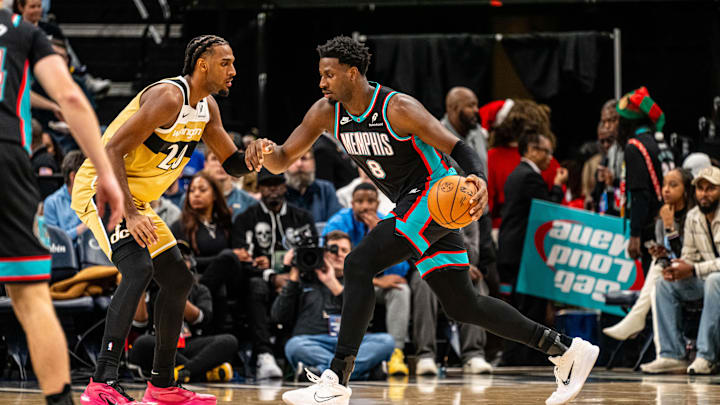 Dec 20, 2025; Memphis, Tennessee, USA; Memphis Grizzlies power forward Jaren Jackson Jr. (8) drives into defender Wizards Center Alex Sarr (20) in the first quarter at FedExForum. Mandatory Credit: Matthew Smith-Imagn Images