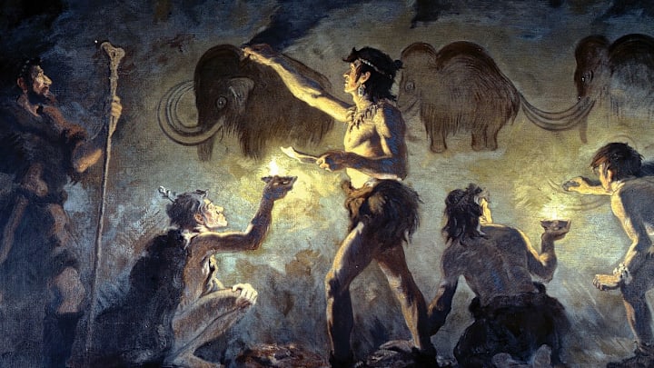 A 1920 mural by paleoartist Charles Robert Knight depicting Cro-Magnon people painting on cave walls at Font-de-Gaume, France.