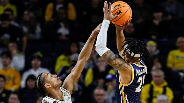 Michigan guard Kobe Bufkin (2) tries to block a shot from Toledo guard Dante Maddox Jr. (21) during