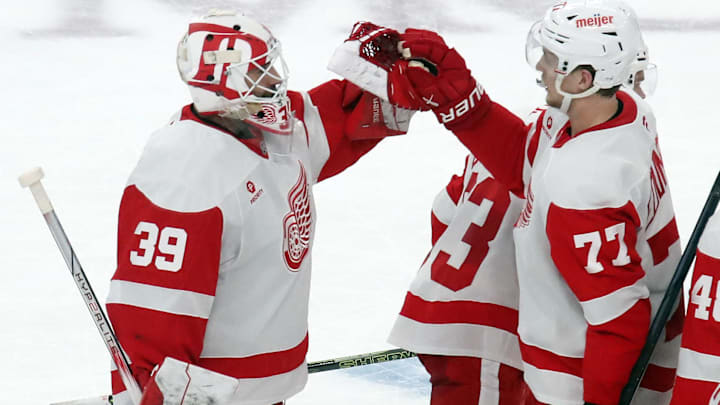 Nov 13, 2024; Pittsburgh, Pennsylvania, USA;  Detroit Red Wings goaltender Cam Talbot (39) and defenseman Simon Edvinsson (77) celebrate after defeating the Pittsburgh Penguins in overtime at PPG Paints Arena. Mandatory Credit: Charles LeClaire-Imagn Images