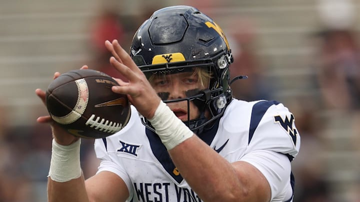 Nov 1, 2025; Houston, Texas, USA; West Virginia Mountaineers quarterback Scotty Fox Jr. (15) takes a snap against the Houston Cougars  in the first half at TDECU Stadium. Mandatory Credit: Thomas Shea-Imagn Images