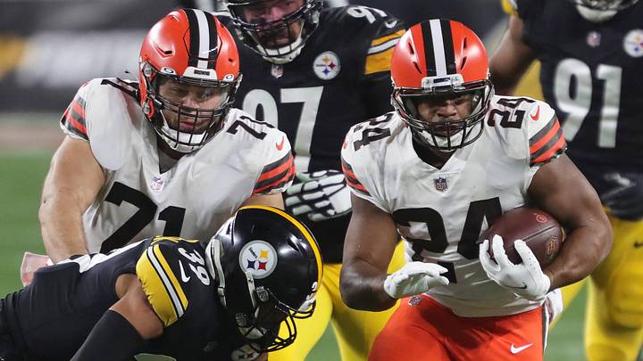 Cleveland Browns running back Nick Chubb (24) rushes for a first down as Cleveland Browns offensive tackle Jedrick Wills (71) blocks during the second half of an NFL wild-card playoff football game, Sunday, Jan. 10, 2021, in Pittsburgh, Pennsylvania. [Jeff Lange/Beacon Journal]
