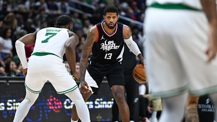 Dec 23, 2023; Los Angeles, California, USA; Los Angeles Clippers forward Paul George (13) dribbles the ball against Boston Celtics forward Jaylen Brown (7) during the third quarter at Crypto.com Arena. Mandatory Credit: Jonathan Hui-Imagn Images