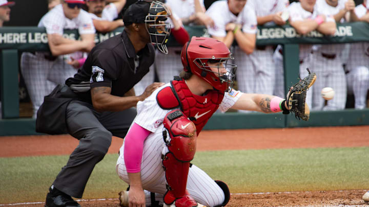 Alabama catcher John Lemm catches the ball in the second game of the series against Rhode Island on Feb. 21, 2026.