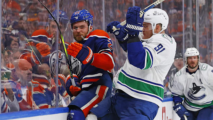 Vancouver Canucks defensemen Nikita Zadorov (91) checks Edmonton Oilers Forward