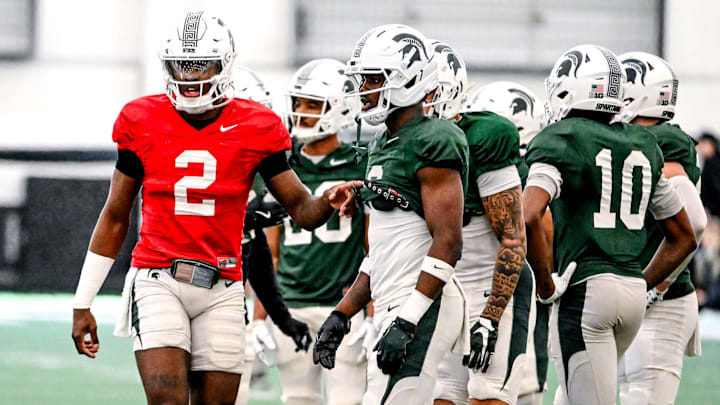 Michigan State quarterback Aidan Chiles, left, talks with Nick Marsh during a break in football practice on Tuesday, April 8, 2025, in East Lansing.