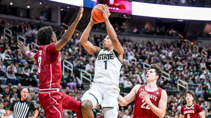 Michigan State's Jeremy Fears Jr., center, scores between Colgate's Jalen Cox, left, and Andrew Alekseyenko during the first half on Monday, Nov. 3, 2025, at the Breslin Center in East Lansing.