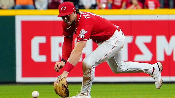 Cincinnati Reds shortstop Kyle Farmer (17) is unable to reach a ground ball hit.