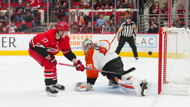 Dec 14, 2025; Raleigh, North Carolina, USA; Carolina Hurricanes right wing Andrei Svechnikov (37) scores the game winner in the shootout past Philadelphia Flyers goaltender Dan Vladar (80) at Lenovo Center. Mandatory Credit: James Guillory-Imagn Images