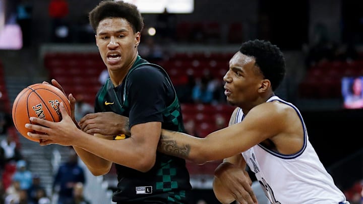 Freedom High School's Donovan Davis (24) is fouled by Milwaukee Academy of Science's Devin Brown (12) during the WIAA Division 3 state championship game on Saturday, March 22, 2025, at the Kohl Center in Madison, Wis. Milwaukee Academy of Science won the game, 57-54.