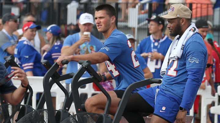 Injured Bills Cole Bishop and Mike Edwards hit the conditioning bikes as they watch practice from the sidelines.