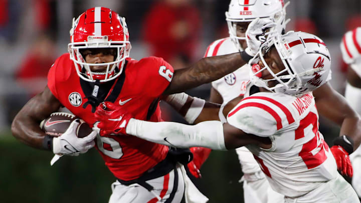 Georgia wide receiver Dominic Lovett (6) stiff arms Ole Miss safety Trey Washington (25) moves the ball during the first half of a NCAA college football game against Ole Miss in Athens, Ga., on Saturday, Nov. 11, 2023.