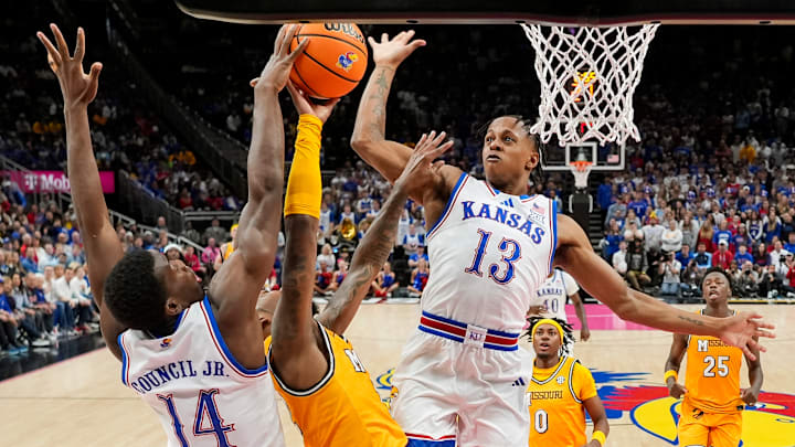 Dec 7, 2025; Kansas City, Missouri, USA; Missouri Tigers guard Sebastian Mack (12) shoots against Kansas Jayhawks guard Melvin Council Jr. (14) and guard Elmarko Jackson (13) during the second half at T-Mobile Center. Dec 7, 2025; Kansas City, Missouri, USA; Missouri Tigers guard Sebastian Mack (12) shoots against Kansas Jayhawks guard Melvin Council Jr. (14) and guard Elmarko Jackson (13) during the second half at T-Mobile Center.