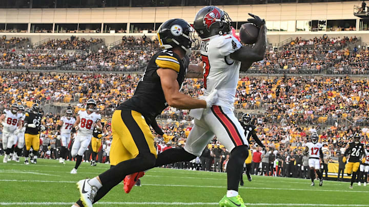 Aug 16, 2025; Pittsburgh, Pennsylvania, USA; Tampa Bay Buccaneers running back Bucky Irving (7) catches a touchdown pass in front of Pittsburgh Steelers linebacker Payton Wilson (41) during the first quarter at Acrisure Stadium. Mandatory Credit: Barry Reeger-Imagn Images