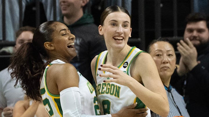 Oregon’s Deja Kelly, left, and Elisa Mevius celebrate as the Ducks take the lead in the fourth quarter against Iowa at Matthew Knight Arena on Sunday, Jan. 19, 2025.