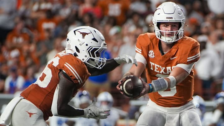 Texas Longhorns quarterback Quinn Ewers (3) hands the ball off to Texas Longhorns running back Quintrevion Wisner (26) in the fourth quarter against Kentucky Wildcats during the second half of an NCAA college football game at Darrell K Royal Texas Memorial Stadium, Austin, Texas, Saturday, Nov 24, 2024.