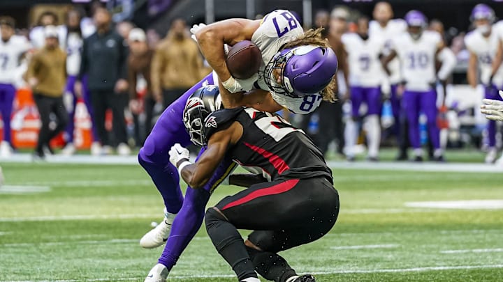 Nov 5, 2023; Atlanta, Georgia, USA; Minnesota Vikings tight end T.J. Hockenson (87) is tackled by Atlanta Falcons cornerback A.J. Terrell (24) during the second half at Mercedes-Benz Stadium. Mandatory Credit: Dale Zanine-Imagn Images