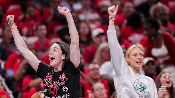 Indiana Fever guard Caitlin Clark (22) and Indiana Fever guard Sophie Cunningham (8) celebrate from the bench Tuesday, Sept. 16, 2025, during Game 2 of a WNBA playoff matchup between the Indiana Fever and the Atlanta Dream at Gainbridge Fieldhouse in Indianapolis.