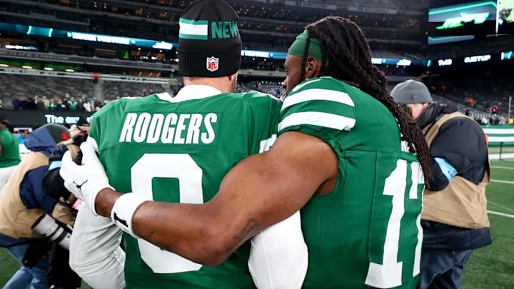 Jan 5, 2025; East Rutherford, New Jersey, USA; New York Jets quarterback Aaron Rodgers (8) and wide receiver Davante Adams (17) walk on the field after the Jets win over the Miami Dolphins at MetLife Stadium. Mandatory Credit: Ed Mulholland-Imagn Images