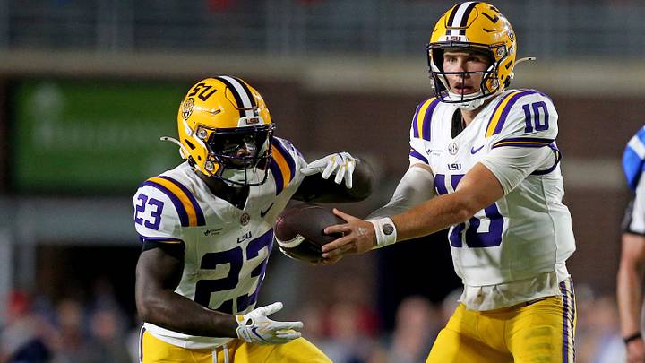 LSU Tigers quarterback Sam Leavitt (10) hands the ball off to running back Stacy Gage (23) during the fourth quarter against the Mississippi Rebels at Vaught-Hemingway Stadium. 