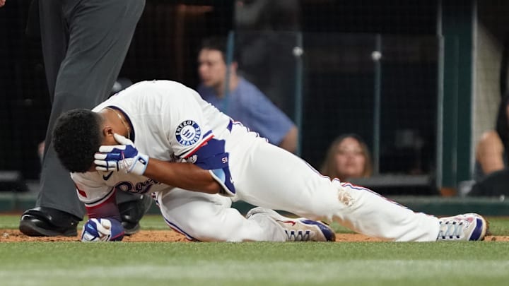 Marcus Semien lays on the ground after being hit by a pitch 
