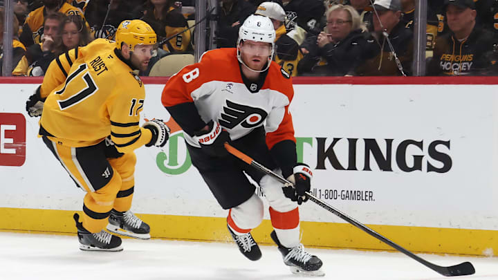 Apr 20, 2026; Pittsburgh, Pennsylvania, USA;  Philadelphia Flyers defenseman Cam York (8) moves the puck against Pittsburgh Penguins right wing Bryan Rust (17) during the third period in game two of the first round of the 2026 Stanley Cup Playoffs at PPG Paints Arena. Mandatory Credit: Charles LeClaire-Imagn Images