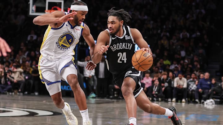 Mar 6, 2025; Brooklyn, New York, USA;  Brooklyn Nets guard Cam Thomas (24) drives past Golden State Warriors guard Moses Moody (4) in the third quarter at Barclays Center. Mandatory Credit: Wendell Cruz-Imagn Images