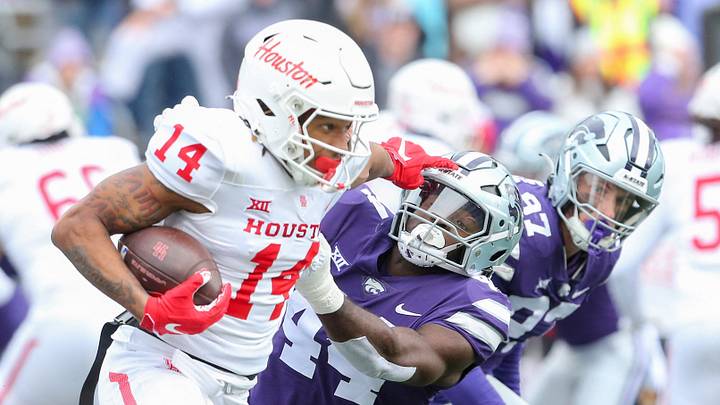 Oct 28, 2023; Manhattan, Kansas, USA; Houston Cougars wide receiver Jonah Wilson (14) stiff arms Kansas State Wildcats linebacker Tobi Osunsanmi (44) during the third quarter at Bill Snyder Family Football Stadium. Mandatory Credit: Scott Sewell-USA TODAY Sports Oct 28, 2023; Manhattan, Kansas, USA; Houston Cougars wide receiver Jonah Wilson (14) stiff arms Kansas State Wildcats linebacker Tobi Osunsanmi (44) during the third quarter at Bill Snyder Family Football Stadium. Mandatory Credit: Scott Sewell-USA TODAY Sports