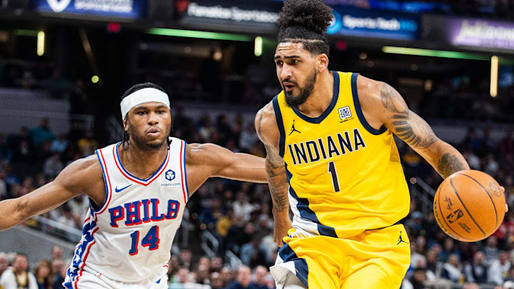 Jan 18, 2025; Indianapolis, Indiana, USA; Indiana Pacers forward Obi Toppin (1) dribbles the ball while Philadelphia 76ers guard Ricky Council IV (14) defends in the first half at Gainbridge Fieldhouse. Mandatory Credit: Trevor Ruszkowski-Imagn Images
