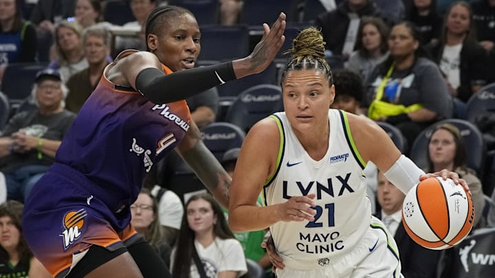 Jul 16, 2025; Minneapolis, Minnesota, USA; Minnesota Lynx guard Kayla McBride (2) works around Phoenix Mercury forward Natasha Mack (4) in the first quarter at Target Center. Mandatory Credit: Bruce Kluckhohn-Imagn Images